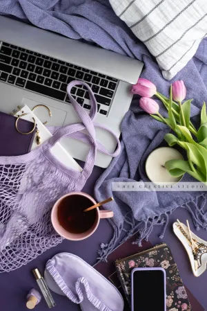 Tea, Tulips & Laptop on Purple. Stock Photo.